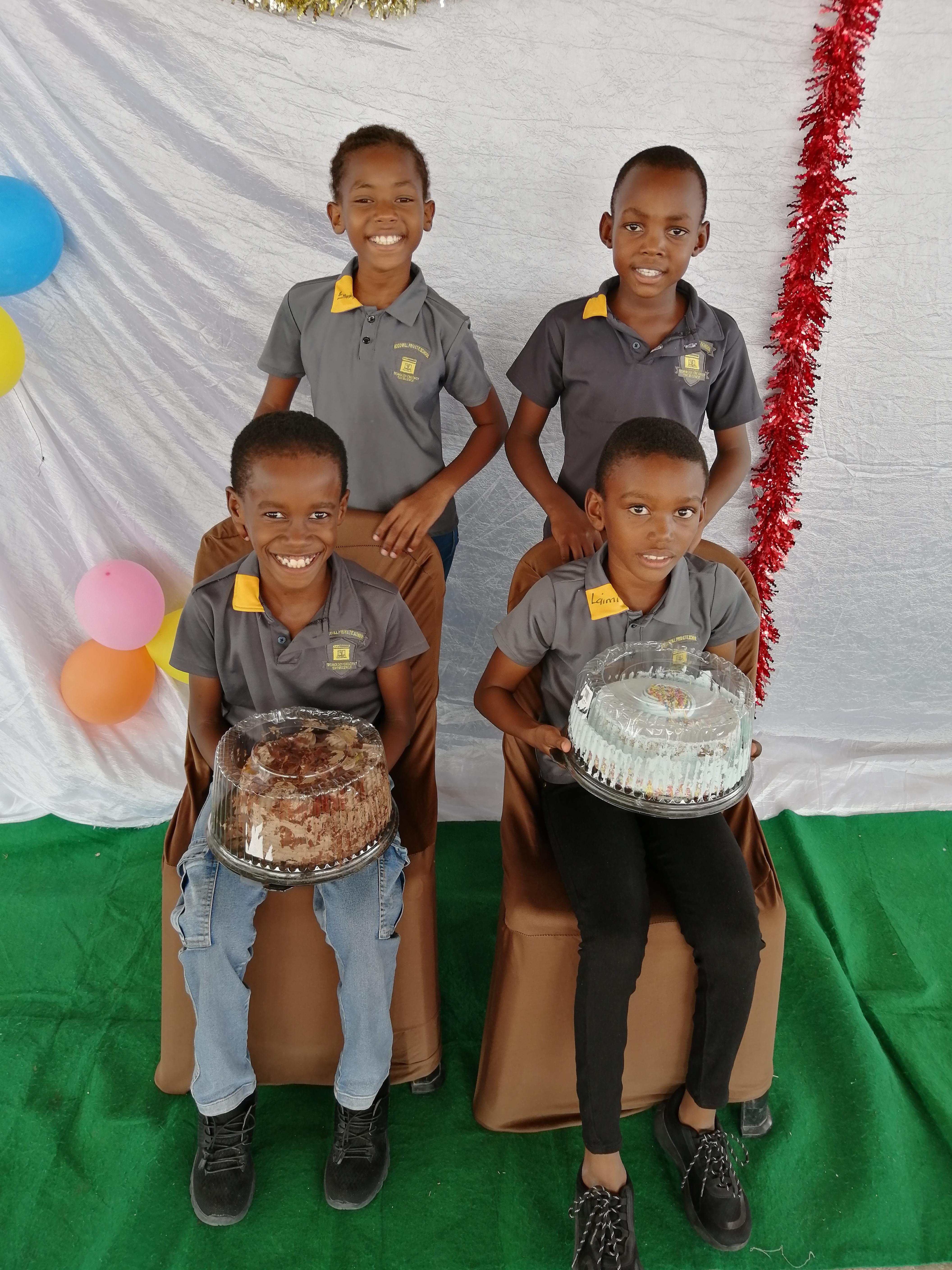 Students celebrating birthdays with cakes