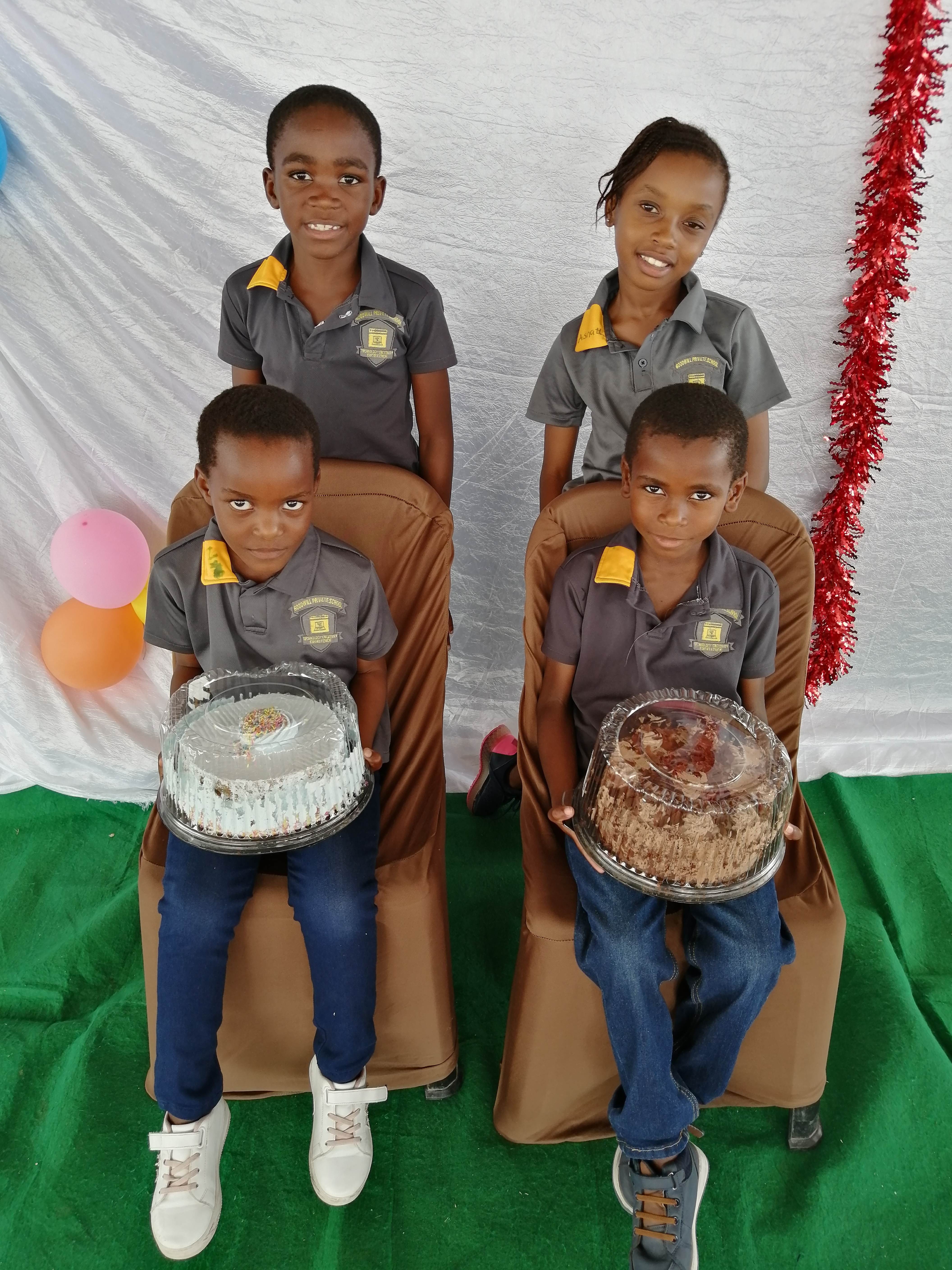 Students celebrating birthdays with cakes